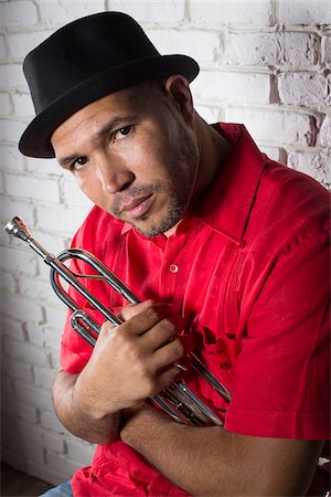 Portrait of Musician holding Trumpet, Studio Shot Stock Photo - Premium Royalty-Free, Code: 600-06803951