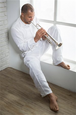 simsearch:700-06465989,k - Portrait of Musician Playing Trumpet by Window, Italy Stock Photo - Premium Royalty-Free, Code: 600-06803960