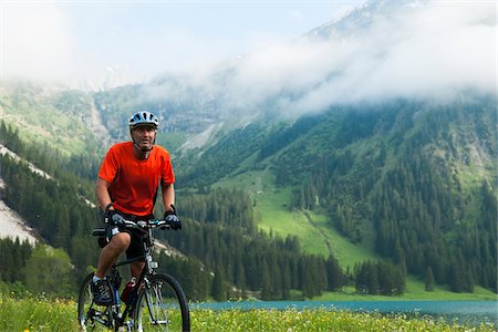Mature Man Riding Mountain Bike by Vilsalpsee, Tannheim Valley, Tyrol, Austria Stock Photo - Premium Royalty-Free, Code: 600-06819406