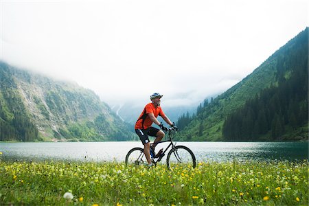Mature Man Riding Mountain Bike by Vilsalpsee, Tannheim Valley, Tyrol, Austria Stock Photo - Premium Royalty-Free, Code: 600-06819408