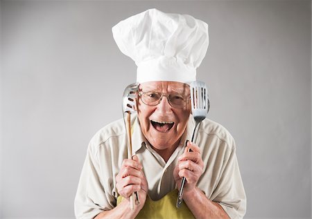 simsearch:600-06397406,k - Senior Man with Cooking Utensils wearing Apron and Chef's Hat, Studio Shot Stock Photo - Premium Royalty-Free, Code: 600-06819434