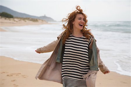 Woman Laughing on Beach, Sardinia, Italy Stock Photo - Premium Royalty-Free, Code: 600-06826327