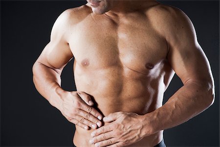 Close-up of Muscular Man with Hands on Stomach, Studio Shot Photographie de stock - Premium Libres de Droits, Code: 600-06841747