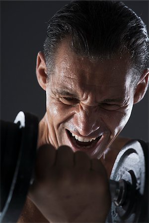 sweaty - Close-up of Man Lifting Weights, Studio Shot Stock Photo - Premium Royalty-Free, Code: 600-06841754