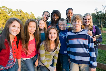 simsearch:600-03848745,k - Group portrait of pre-teens standing outdoors, smiling and looking at camera, Florida, USA Stock Photo - Premium Royalty-Free, Code: 600-06841925
