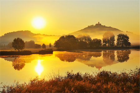 sky dawn - Wachsenburg Castle with Morning Mist and Sun reflecting in Lake at Dawn, Drei Gleichen, Thuringia, Germany Stock Photo - Premium Royalty-Free, Code: 600-06899715