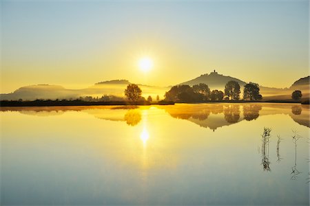 sun reflected lake - Wachsenburg Castle with Morning Mist and Sun reflecting in Lake at Dawn, Drei Gleichen, Thuringia, Germany Stock Photo - Premium Royalty-Free, Code: 600-06899716