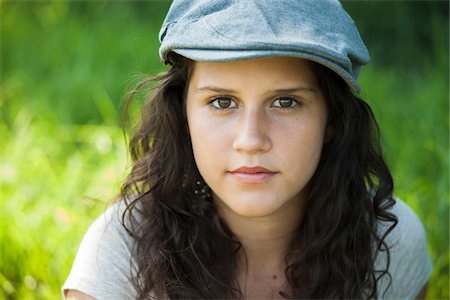 Close-up portrait of teenaged girl wearing cap outdoors, looking at camera, Germany Stock Photo - Premium Royalty-Free, Code: 600-06899828