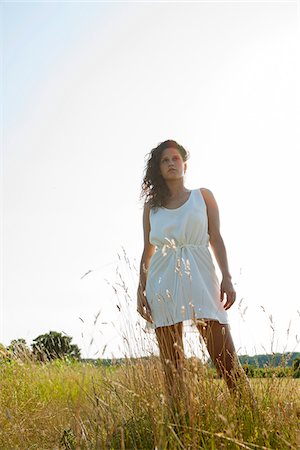 simsearch:600-06553417,k - Teenaged girl standing in field on summer day, looking into the distance, Germany Stock Photo - Premium Royalty-Free, Code: 600-06899848