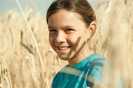 field of grain - Close-up portrait of girl standing in wheat field, Germany Stock Photo - Premium Royalty-Free, Code: 600-06899874