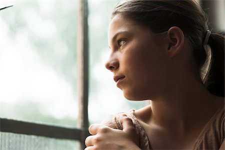 female only (human) - Girl looking out of window, Germany Stock Photo - Premium Royalty-Free, Code: 600-06899907