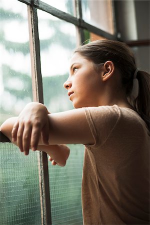 Girl looking out of window, Germany Stock Photo - Premium Royalty-Free, Code: 600-06899908