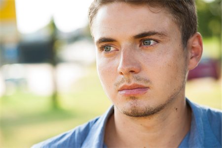 portrait looking away - Close-up portrait of young man outdoors, Germany Stock Photo - Premium Royalty-Free, Code: 600-06899928