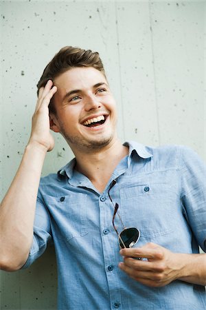 simsearch:600-06368307,k - Portrait of young man outdoors, laughing, Germany Stock Photo - Premium Royalty-Free, Code: 600-06899999