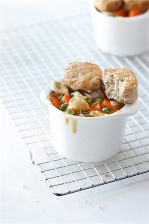 Single Serving of Chicken Pot Pie with Carrots, Mushrooms, and Peas with Whole Wheat Biscuit Topping, Studio Shot Stock Photo - Premium Royalty-Free, Code: 600-06892684