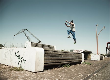 Teenaged boy jumping over barrier, freerunning, Germany Photographie de stock - Premium Libres de Droits, Code: 600-06900018