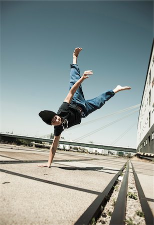 extreme teens - Teenaged boy doing handstand on cement road, freerunning, Germany Stock Photo - Premium Royalty-Free, Code: 600-06900022