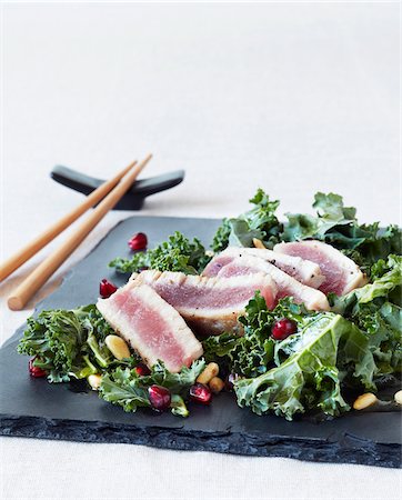 salad white background not dog not people - Ahi Tuna & Kale Salad with Pine Nuts and Pomegranates, Studio Shot Stock Photo - Premium Royalty-Free, Code: 600-06934985