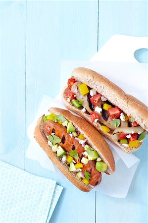 simsearch:600-07311139,k - Overhead View of Grilled Sausages with Fresh Vegetable Toppings in Whole Wheat Buns, Studio Shot Stock Photo - Premium Royalty-Free, Code: 600-06935013