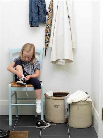 shoes kids - Girl Tying Shoes in Front Hallway, Toronto, Ontario, Canada Stock Photo - Premium Royalty-Free, Code: 600-06935026