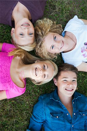 Overhead View of Teenagers Lying on Grass, Mannheim, Baden-Wurttemberg, Germany Stock Photo - Premium Royalty-Free, Code: 600-06939780