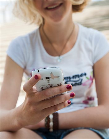 seated teenager - Teenage Girl using Cell Phone Outdoors, Mannheim, Baden-Wurttemberg, Germany Stock Photo - Premium Royalty-Free, Code: 600-06939793