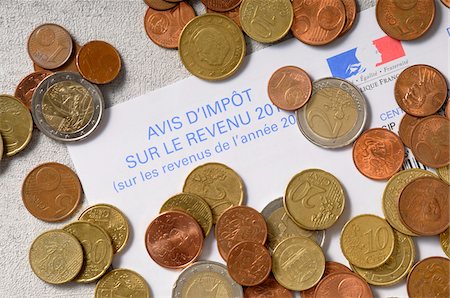 paying images - French Income Tax Receipt and Eruo Coins Stock Photo - Premium Royalty-Free, Code: 600-06961796