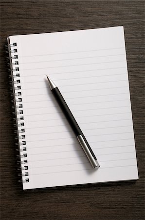 Close-up of blank notebook and writing pen on wooden background Stock Photo - Premium Royalty-Free, Code: 600-06961800