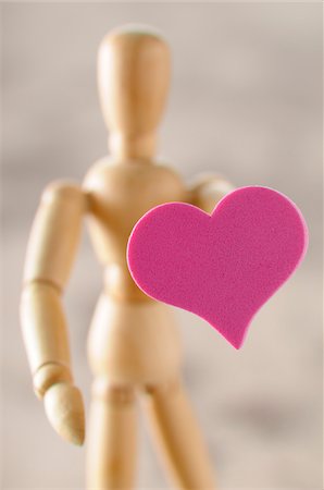 Wooden artist's mannequin holding heart Stock Photo - Premium Royalty-Free, Code: 600-06961802