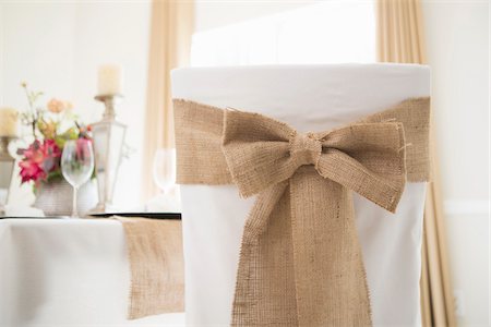 shabby chic - Back view of covered chair with sash and table setting for fine dining Stock Photo - Premium Royalty-Free, Code: 600-06961835