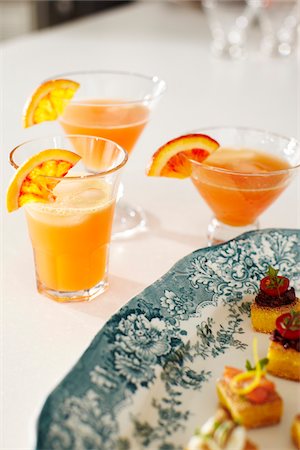 fruit garnish on cocktails - Cocktails and Appetisers on Table at Cocktail Party, Studio Shot Stock Photo - Premium Royalty-Free, Code: 600-06963774