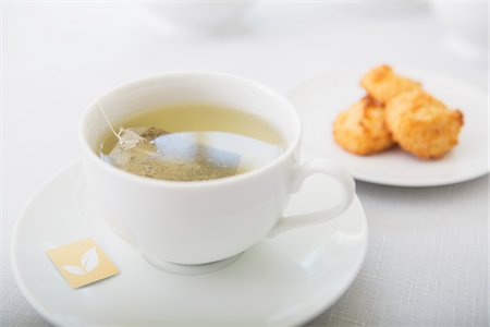 relax tea - Cup of tea in porcelain white teacup with saucer and plate of coconut macaroons, studio shot Stock Photo - Premium Royalty-Free, Code: 600-07067033