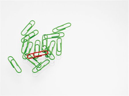 different unique - Green and red paper clips on white background, studio shot Stock Photo - Premium Royalty-Free, Code: 600-07067134