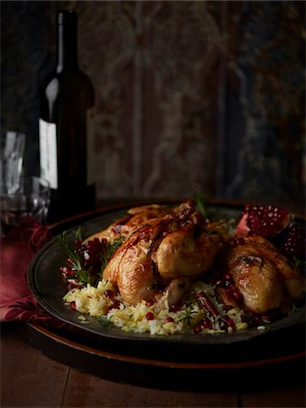 Roasted Cornish Hen with Rice and Pomegranate, Studio Shot Stock Photo - Premium Royalty-Free, Code: 600-07067632