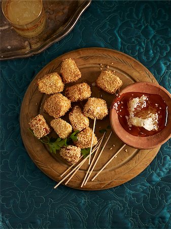 Overhead View of Cubes of Haloumi covered in Sesame Seeds with Honey for Dipping, Studio Shot Stock Photo - Premium Royalty-Free, Code: 600-07067667