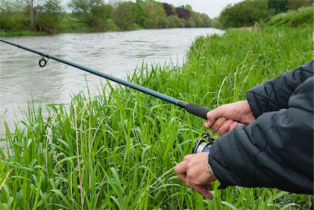 spin fishing - Close-up of man fishing at Mount Juliet Estate, River Nore, Thomastown, County Kilkenny, Leinster, Republic of Ireland Stock Photo - Premium Royalty-Free, Code: 600-07067676