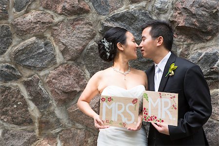 strapless wedding gown - Portrait of Married Couple with Mr and Mrs Signs Stock Photo - Premium Royalty-Free, Code: 600-07117236