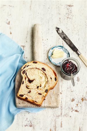 rustic spoon - Overhead View of Slice Of Cinnamon Rasin Bread with Butter and Jam, Studio Shot Stock Photo - Premium Royalty-Free, Code: 600-07110670