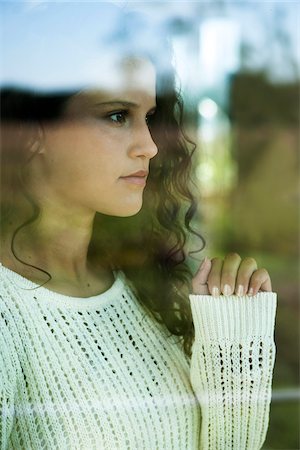 sad girl photos - Close-up portrait of teenage girl looking out window, Germany Stock Photo - Premium Royalty-Free, Code: 600-07148144