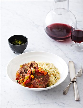 decanter - Risotto and Ossobucco (braised veal shank) on plate with red wine, studsio shot Stock Photo - Premium Royalty-Free, Code: 600-07156163