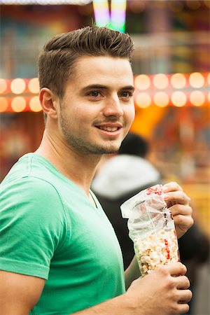 Close-up portrait of young man at amusement park, Germany Stock Photo - Premium Royalty-Free, Code: 600-07156189