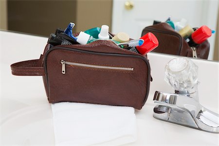 sink overflow - Men's toiletry travel bag on bathroom counter, filled with toothbrush, shaving cream, razor and other grooming products, USA Stock Photo - Premium Royalty-Free, Code: 600-07199735