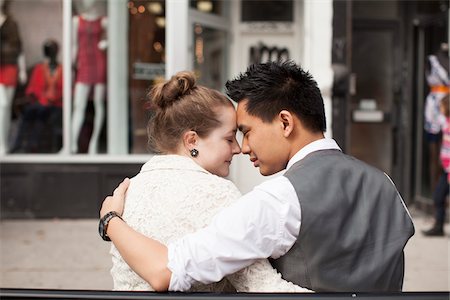 Close-up, backview of couple sitting on bench on city street, Toronto, Ontario, Canada Stock Photo - Premium Royalty-Free, Code: 600-07199742