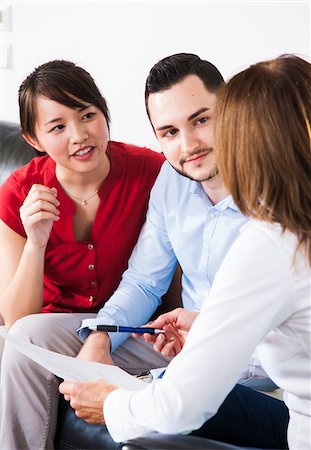 executive consulting - Backview of businesswoman in discussion with young couple, Germany Stock Photo - Premium Royalty-Free, Code: 600-07199924