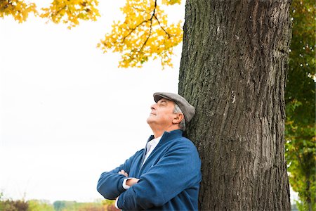 pictures of calm people - Portrait of Senior Man Leaning Against Tree, Mannheim, Baden-Wurttemberg, Germany Stock Photo - Premium Royalty-Free, Code: 600-07192134