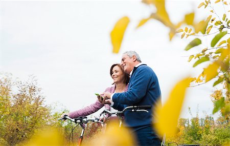 Couple with Bicycles using Cell Phone, Mannheim, Baden-Wurttmeberg, Germany Stock Photo - Premium Royalty-Free, Code: 600-07192144