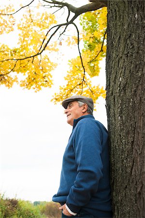 Senior Man leaning against Tree in Autumn, Mannheim, Baden-Wurttemberg, Germany Stock Photo - Premium Royalty-Free, Code: 600-07192149