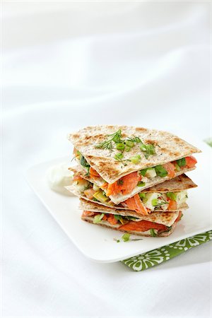 square plate - Stack of Smoked Salmon Quesadillas with Artichoke Hearts, Cream Cheese, Dill, Green Onions, Spinach, and Tomatoes on Whole Wheat Tortillas Stock Photo - Premium Royalty-Free, Code: 600-07204040
