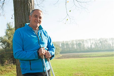 simsearch:600-07237885,k - Senior Man with Nordic Walking Poles by Tree, Mannheim, Baden-Wurttemberg, Germany Stock Photo - Premium Royalty-Free, Code: 600-07237879