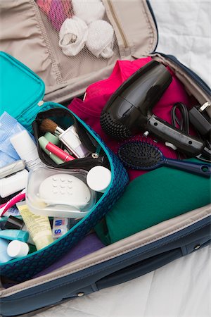 packing - Women's Toiletry Travel Bag in Packed Suitcase Stock Photo - Premium Royalty-Free, Code: 600-07232294